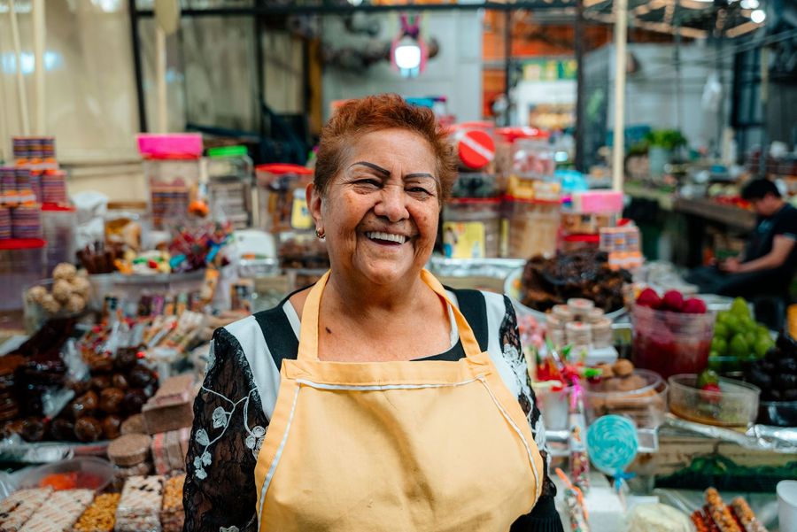 Vendor selling produce at a market stall