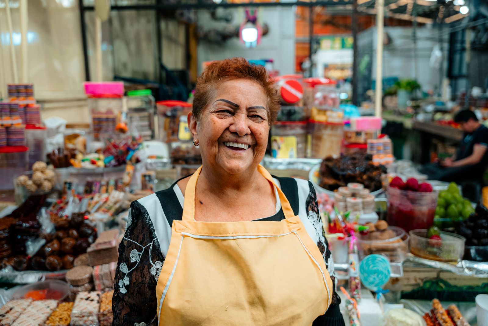 Vendor selling produce at a market stall