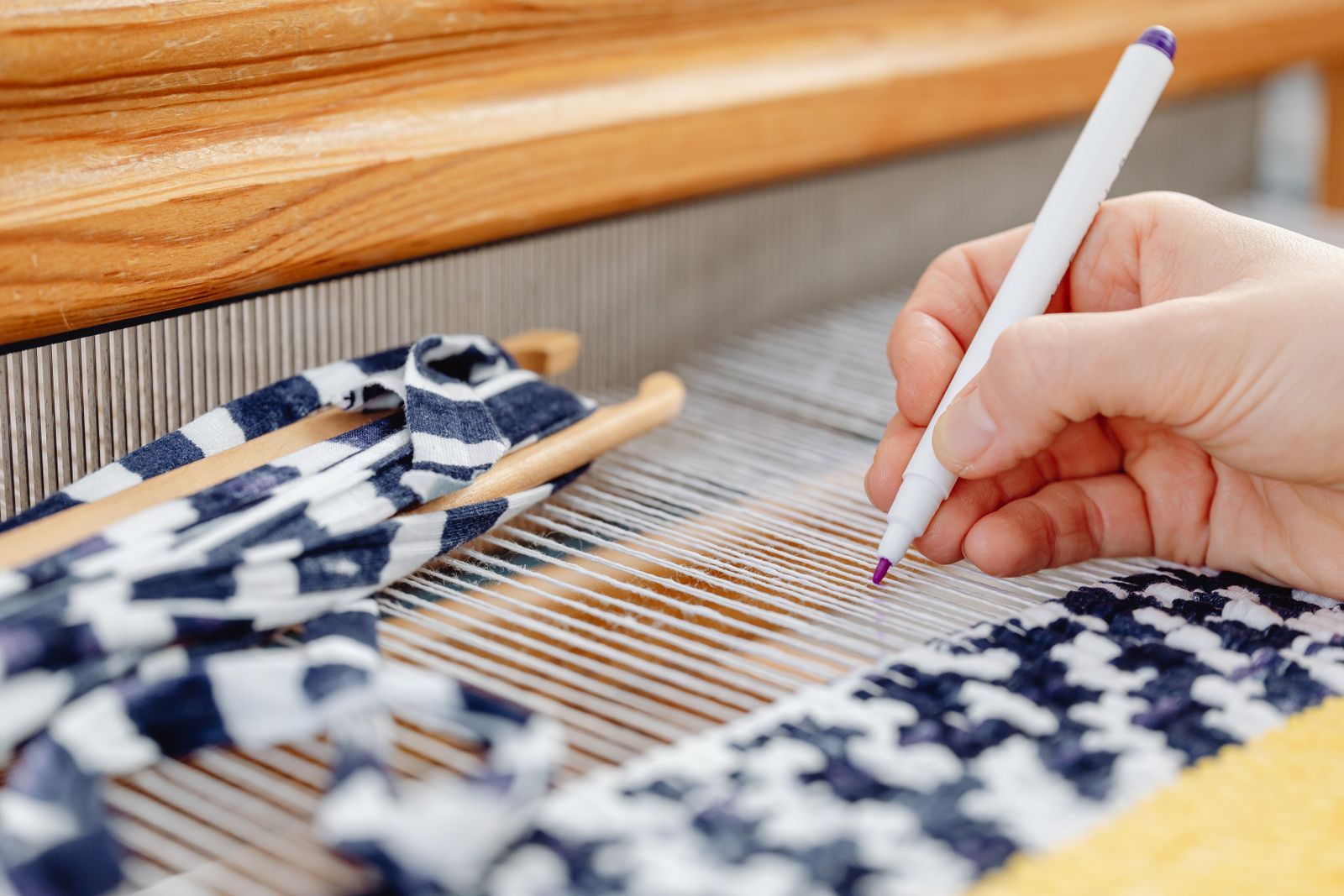 Weaver’s hand at a wooden loom