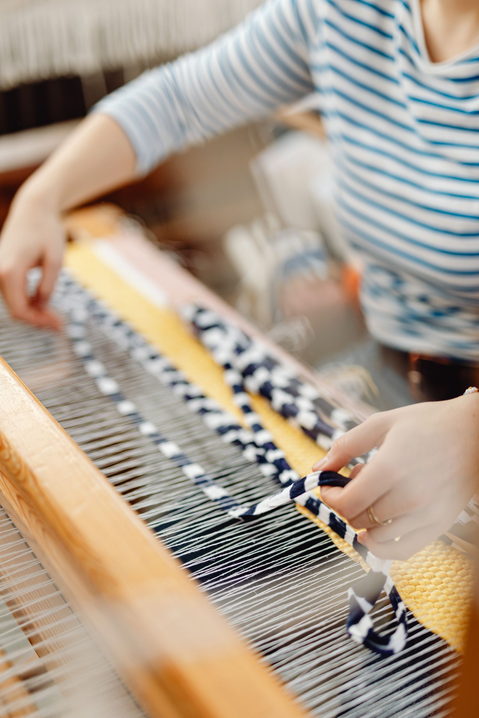 Weaver working at a hand loom