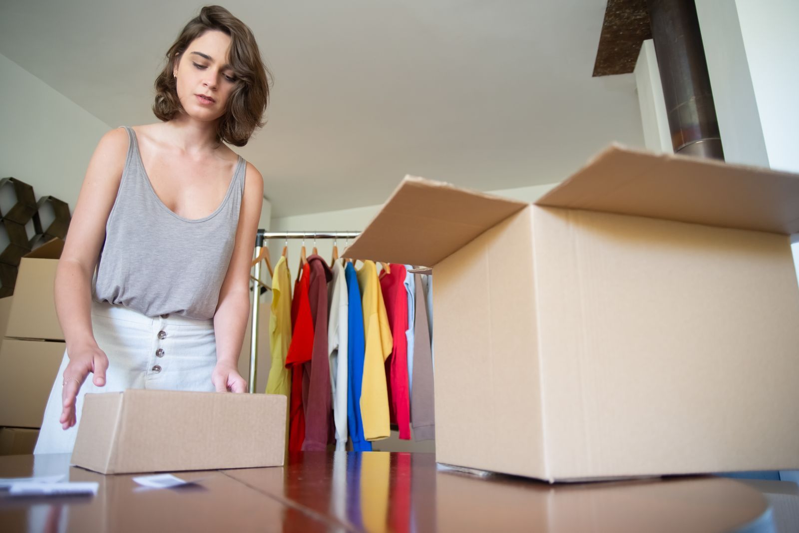 Apparel founder packing orders in her shop